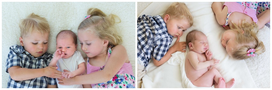 Newborn baby with his young siblings siblings - Sister and brother of a newborn brother being photographed on a rug at home by Jude Conning Photography